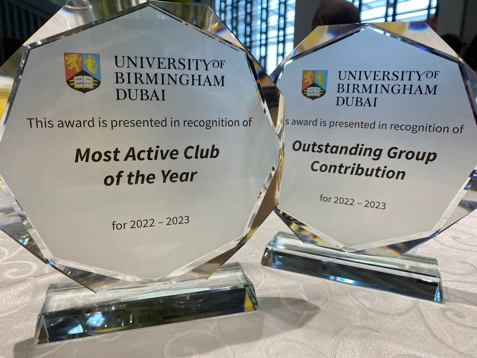Two glass awards from the University of Birmingham Dubai for 2022–2023: Most Active Club of the Year and Outstanding Group Contribution