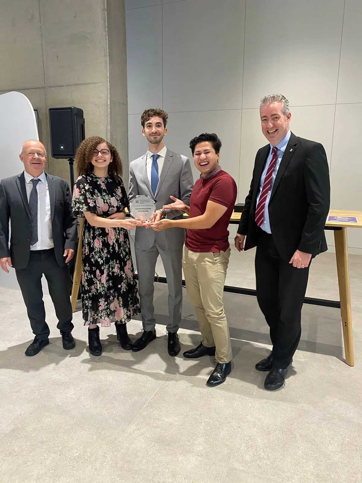 The three founders of the ACM chapter holding the Outstanding Group Contribution award, standing with the provost and the director of the University of Birmingham Dubai