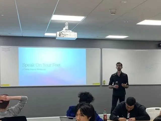 Youssef presenting the Speak On Your Feet table topics workshop to students in a classroom