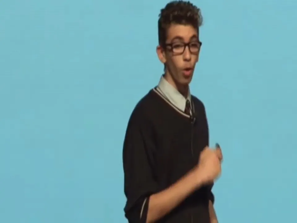 Youssef speaking in front of a slide at TEDxYouth@WASO