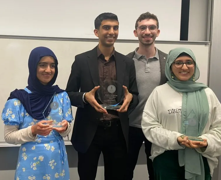 Students holding their trophies from the University of Birmingham Public Speaking Competition 2024